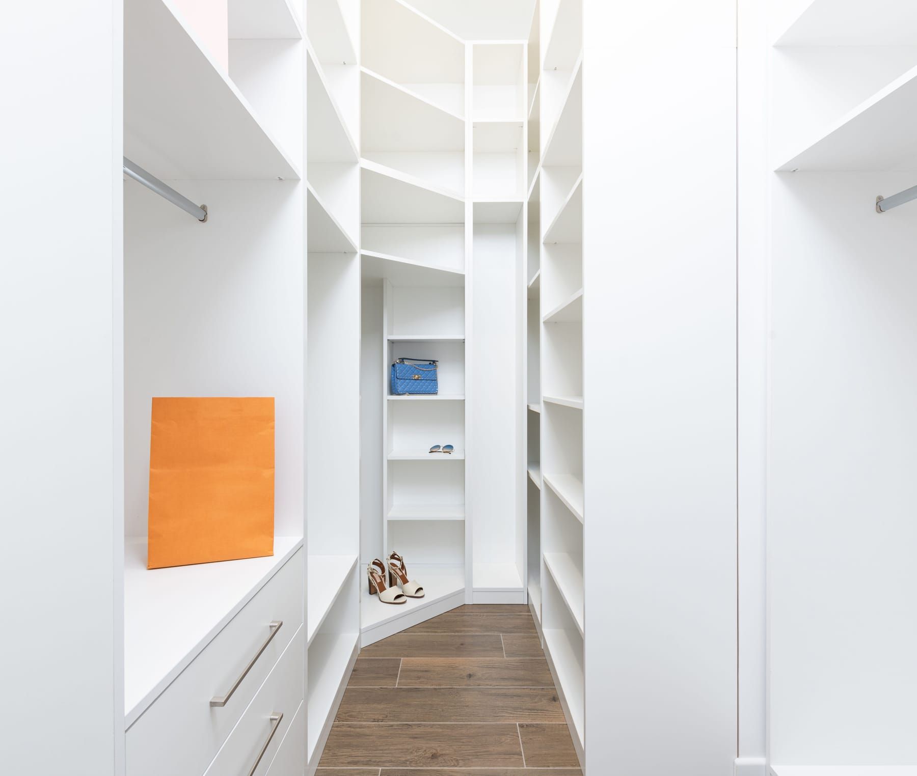 Walk-in dressing room with floor-to-ceiling storage and layered lighting