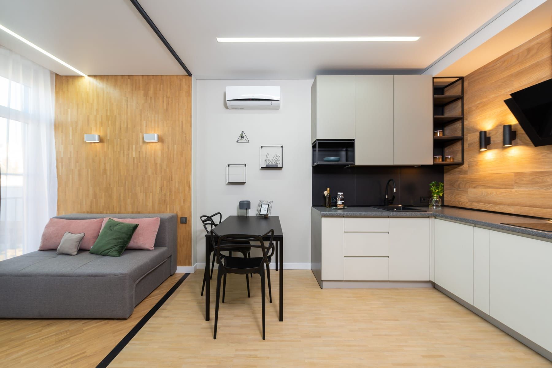 Well-planned small studio interior with multi-functional furniture and full-height storage