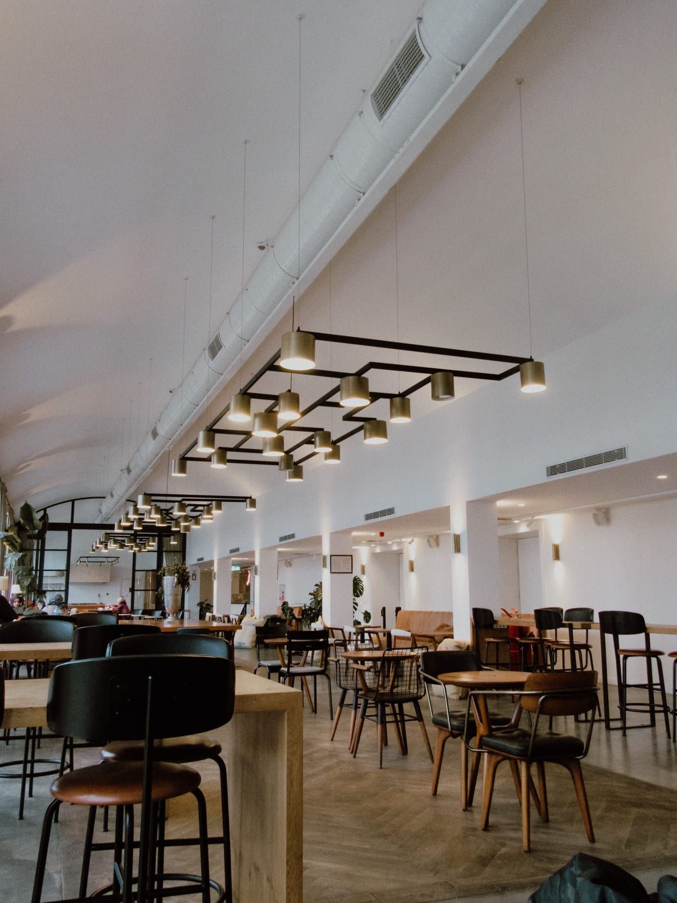 Reception, seating, bar counter and lighting elements included in a SpazioLiv restaurant interior